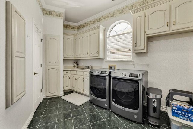 5503 Arch Bridge Ct, Arlington, TX 76017 - laundry area with cabinet space, washer and clothes dryer, dark tile patterned flooring, and crown molding