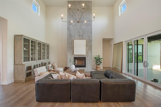 10356 Wild Rose Cir, Forney, TX 75126 - living area with a high ceiling, healthy amount of natural light, a chandelier, and wood finished floors