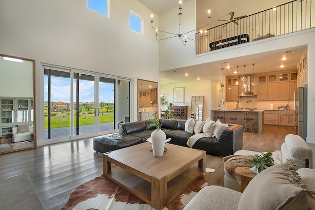 10356 Wild Rose Cir, Forney, TX 75126 - living room with a high ceiling, light wood-type flooring, and a chandelier
