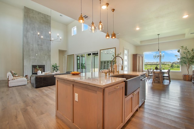 10356 Wild Rose Cir, Forney, TX 75126 - kitchen with a chandelier, a sink, plenty of natural light, and light wood-style flooring