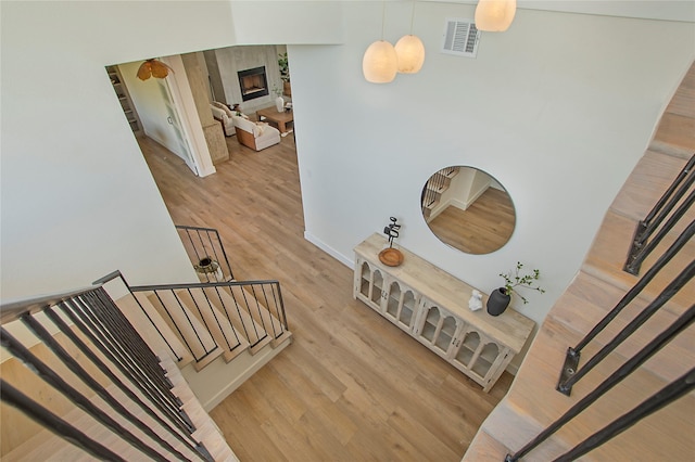 10356 Wild Rose Cir, Forney, TX 75126 - stairs featuring wood finished floors and a glass covered fireplace