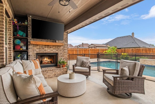 view of patio featuring ceiling fan, a fenced backyard, and an outdoor living space with a fireplace