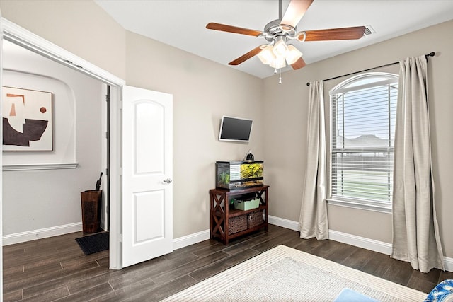 bedroom featuring dark wood finished floors, baseboards, and multiple windows
