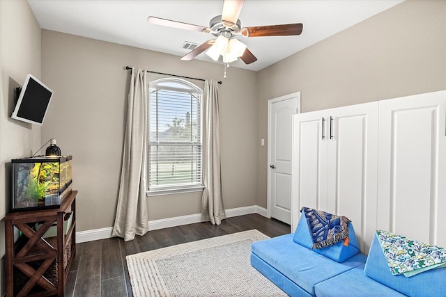 sitting room with ceiling fan, dark wood-style flooring, and baseboards