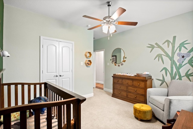 carpeted bedroom featuring a closet, ceiling fan, and baseboards