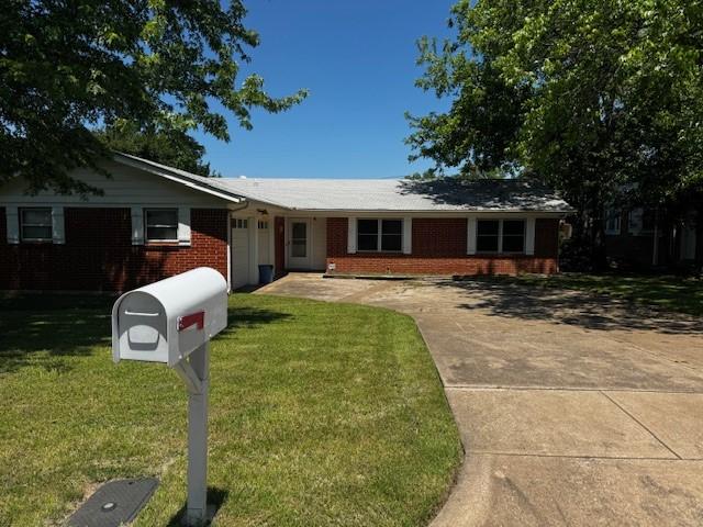 7625 Deaver Dr, North Richland Hills, TX 76180 - ranch-style home featuring brick siding, a front yard, driveway, and a garage