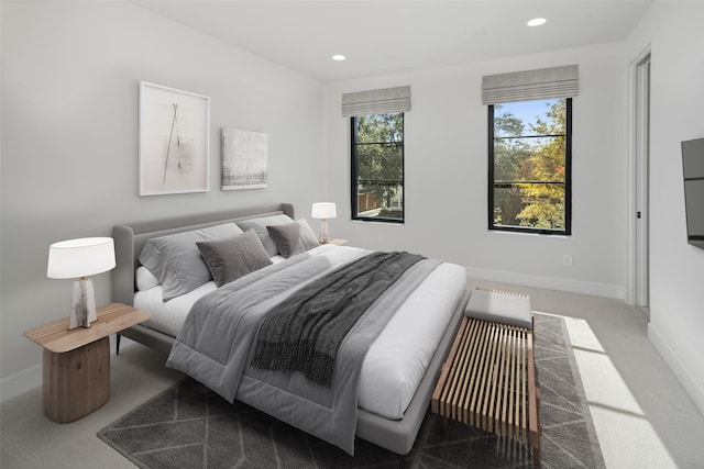 carpeted bedroom featuring recessed lighting and baseboards