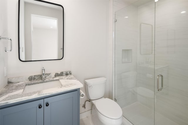 full bathroom with toilet, vanity, and a stall shower