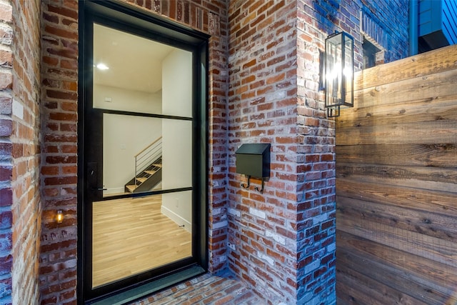 property entrance with brick siding