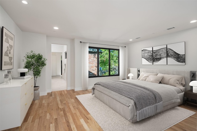 bedroom with light wood-style flooring, recessed lighting, and baseboards