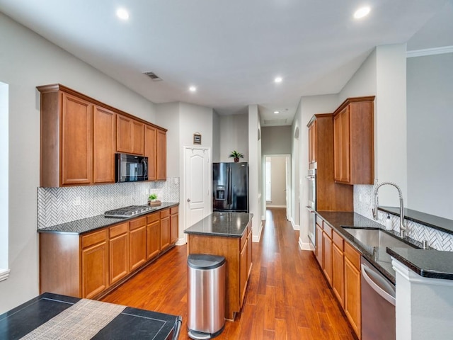 1710 Redcedar Dr, Wylie, TX 75098 - kitchen with black appliances, a sink, a kitchen island, dark wood finished floors, and recessed lighting