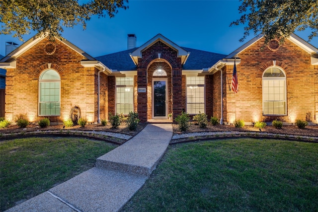 1710 Redcedar Dr, Wylie, TX 75098 - view of front of house with brick siding, a chimney, a front yard, and roof with shingles