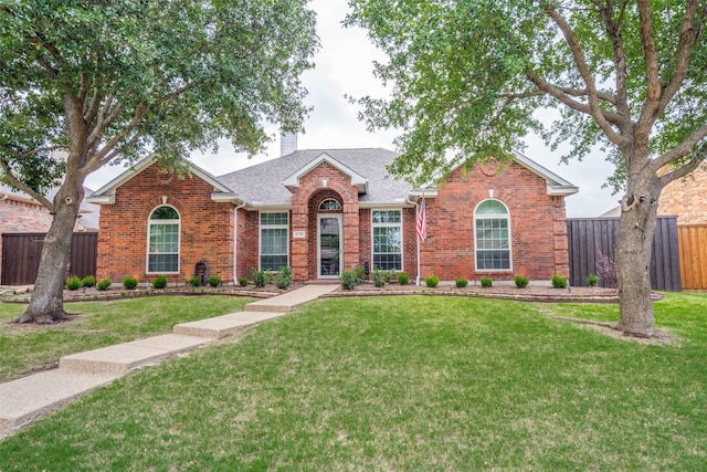 1710 Redcedar Dr, Wylie, TX 75098 - view of front facade featuring brick siding, a chimney, and roof with shingles