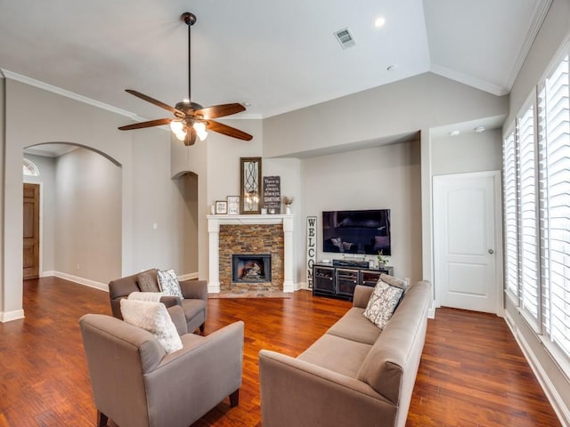 1710 Redcedar Dr, Wylie, TX 75098 - living room with ceiling fan, vaulted ceiling, dark wood-style flooring, arched walkways, and a fireplace