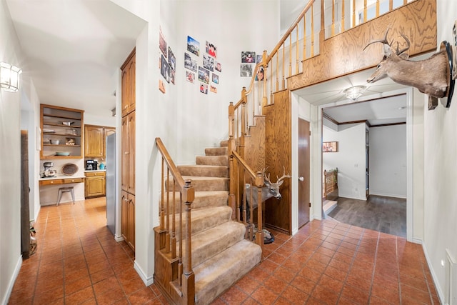 444 Lost Forest Ln, Marlin, TX 76661 - staircase with baseboards, tile patterned floors, and a towering ceiling