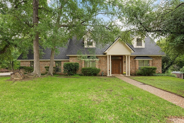 444 Lost Forest Ln, Marlin, TX 76661 - cape cod-style house with a front lawn, brick siding, and a shingled roof