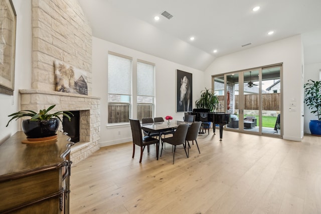 4108 Fall Aster Way, Aubrey, TX 76227 - dining space with light wood-style flooring, recessed lighting, a stone fireplace, baseboards, and lofted ceiling
