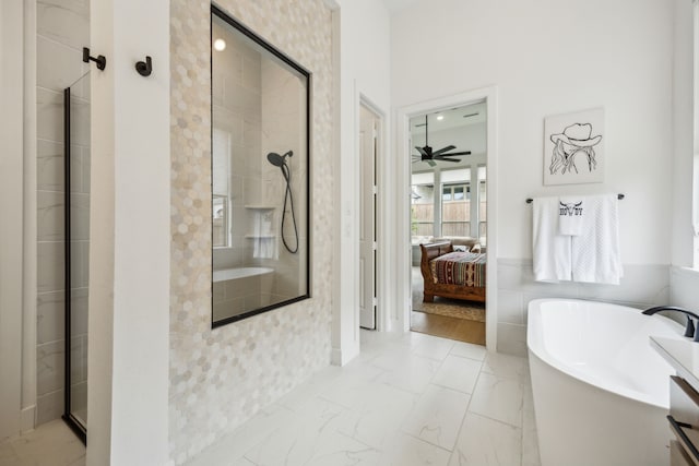 4108 Fall Aster Way, Aubrey, TX 76227 - ensuite bathroom with a stall shower, a freestanding tub, ceiling fan, and marble look tiles