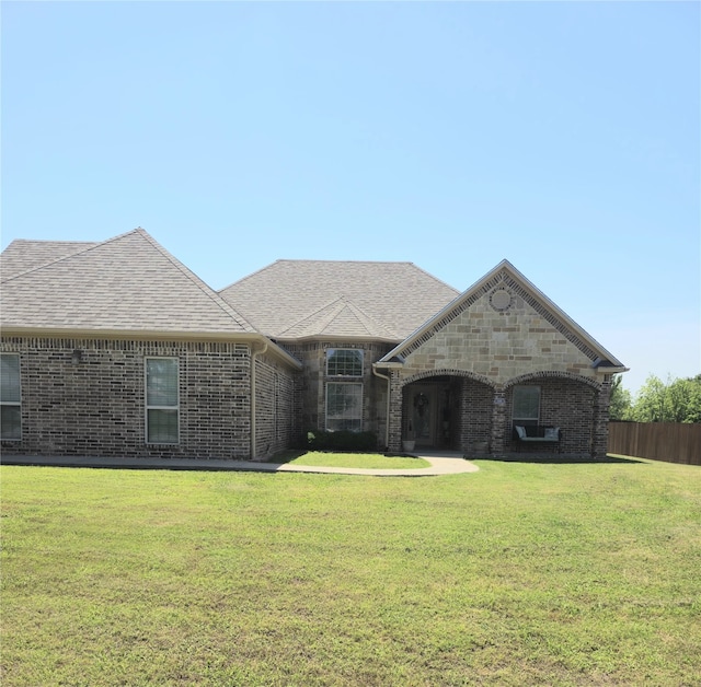 16 Cedar Bayou Cir, Pottsboro, TX 75076 - french country inspired facade featuring a front yard, brick siding, and roof with shingles