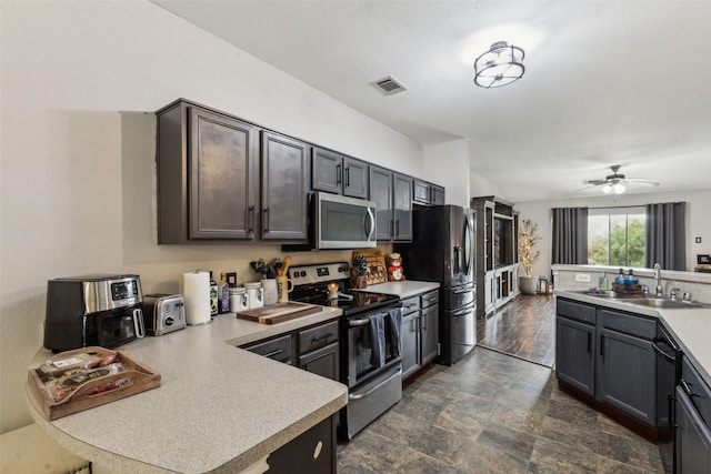 202 Freedom Trl, Forney, TX 75126 - kitchen featuring appliances with stainless steel finishes, a sink, light countertops, a peninsula, and dark stone finish floors