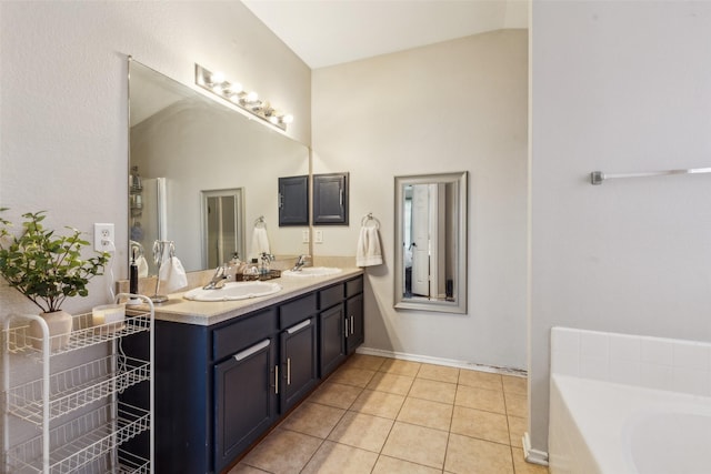 202 Freedom Trl, Forney, TX 75126 - full bathroom with tile patterned floors, double vanity, a bathtub, baseboards, and a high ceiling