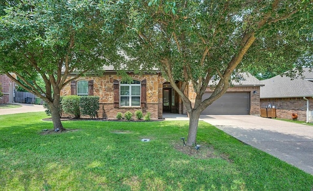 17015 Salado Dr, Woodway, TX 76712 - obstructed view of property featuring a garage, driveway, a front yard, and brick siding