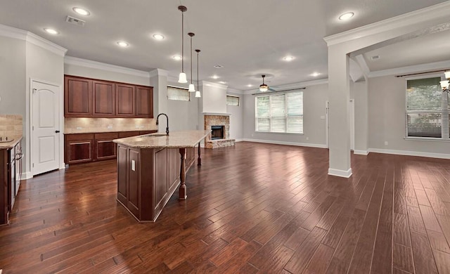 17015 Salado Dr, Woodway, TX 76712 - kitchen with a sink, ceiling fan, open floor plan, crown molding, and decorative backsplash