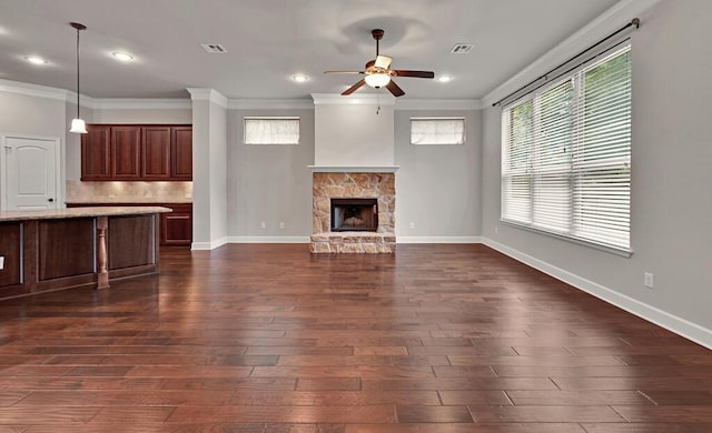 17015 Salado Dr, Woodway, TX 76712 - unfurnished living room featuring a ceiling fan, ornamental molding, dark wood-style flooring, a fireplace, and baseboards