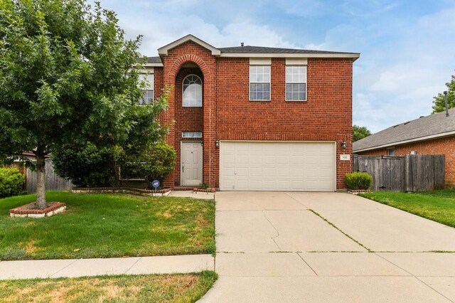 918 Telluride Dr, Arlington, TX 76001 - traditional home with brick siding, an attached garage, and driveway