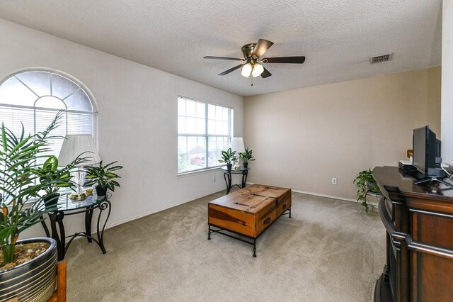 918 Telluride Dr, Arlington, TX 76001 - living area featuring ceiling fan, light carpet, and a textured ceiling