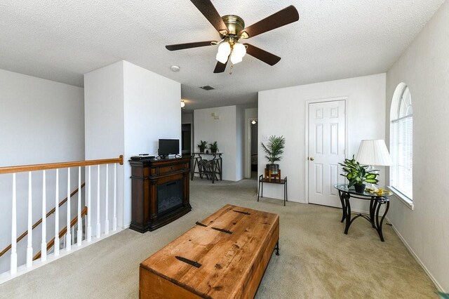 918 Telluride Dr, Arlington, TX 76001 - living room featuring light carpet, a ceiling fan, and a textured ceiling