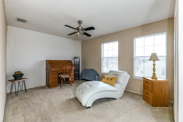 918 Telluride Dr, Arlington, TX 76001 - living area with carpet flooring, a ceiling fan, and a textured ceiling