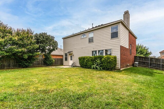918 Telluride Dr, Arlington, TX 76001 - back of house featuring a chimney and brick siding