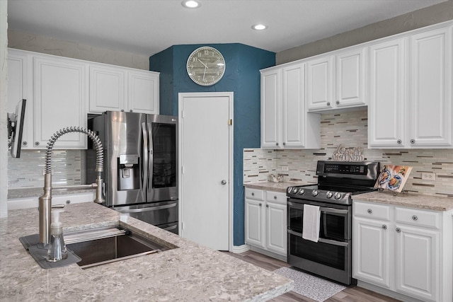 1612 Marble Cove Ln, Denton, TX 76210 - kitchen with stainless steel appliances, a sink, backsplash, white cabinets, and recessed lighting