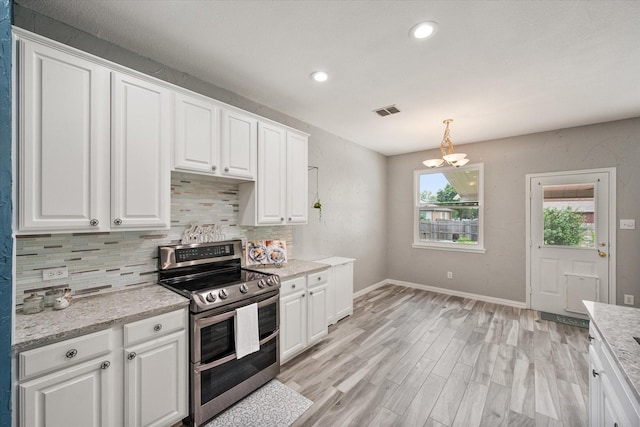 1612 Marble Cove Ln, Denton, TX 76210 - kitchen featuring double oven range, decorative backsplash, white cabinetry, a chandelier, and light wood-type flooring