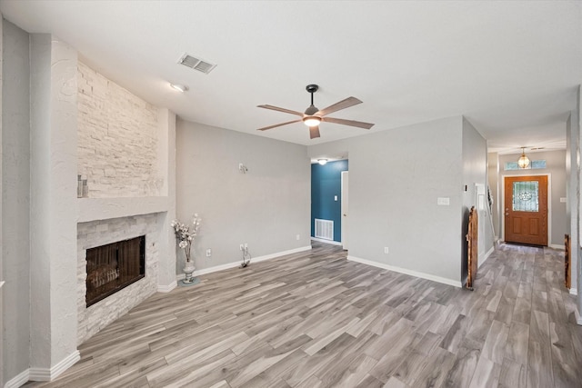 1612 Marble Cove Ln, Denton, TX 76210 - unfurnished living room featuring ceiling fan, wood finished floors, a stone fireplace, and baseboards