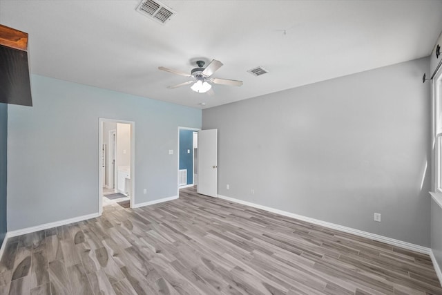 1612 Marble Cove Ln, Denton, TX 76210 - unfurnished bedroom featuring light wood-style flooring, baseboards, ensuite bath, and a ceiling fan