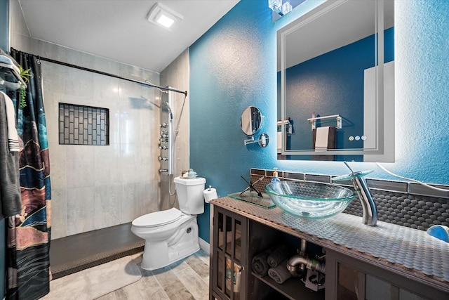 1612 Marble Cove Ln, Denton, TX 76210 - full bathroom with a textured wall, wood finished floors, toilet, curtained shower, and vanity