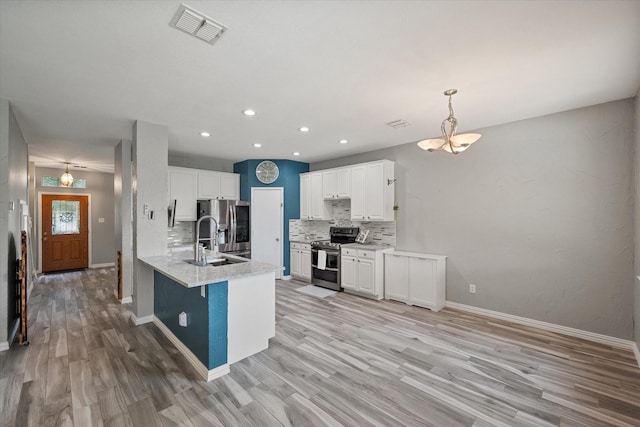 1612 Marble Cove Ln, Denton, TX 76210 - kitchen with stainless steel appliances, decorative backsplash, a sink, white cabinets, and recessed lighting