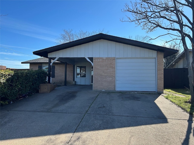 ranch-style house with brick siding, concrete driveway, and a garage