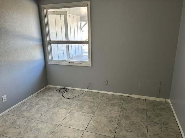 tiled spare room with baseboards