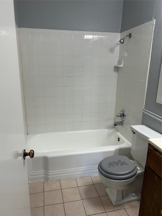 bathroom with toilet, tile patterned flooring, shower / bathtub combination, a textured wall, and vanity