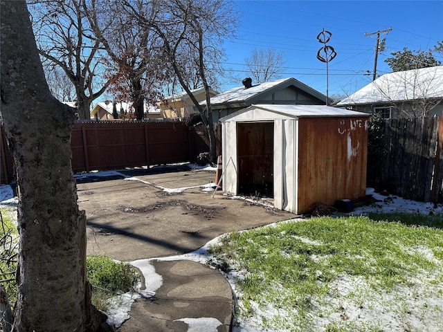view of shed featuring fence