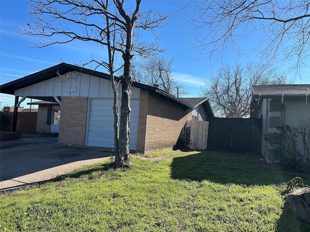 view of property exterior featuring brick siding, driveway, a garage, and board and batten siding
