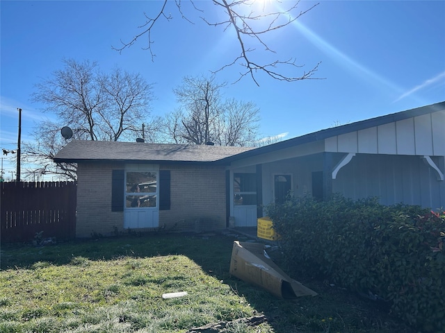 view of front of property with brick siding and roof with shingles