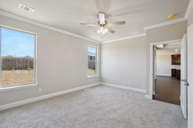 709 Lake Murray Ln, Cleburne, TX 76033 - empty room featuring crown molding, ceiling fan, carpet flooring, baseboards, and a smoke detector