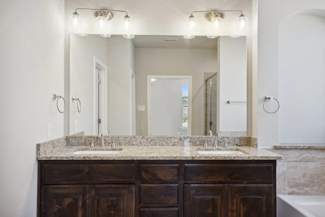 709 Lake Murray Ln, Cleburne, TX 76033 - full bathroom with double vanity, a shower stall, and a tub
