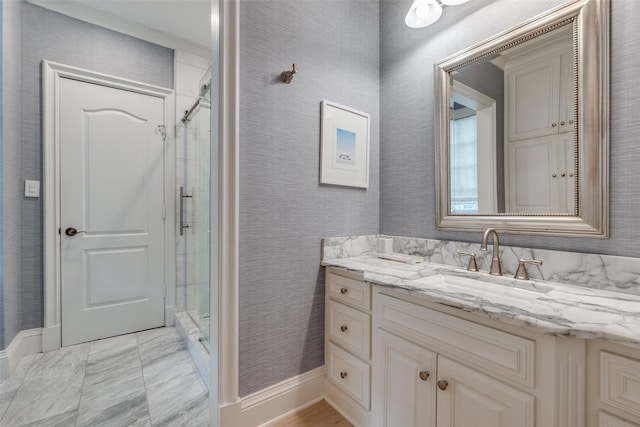 bathroom featuring a shower stall, vanity, and baseboards