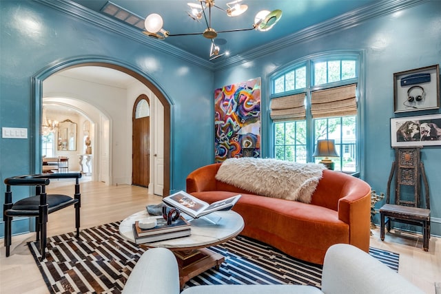 living area featuring a chandelier, arched walkways, light wood-style flooring, and ornamental molding