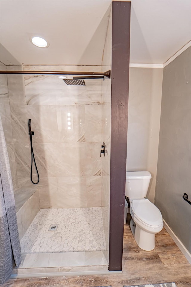 831 Plum St, Graham, TX 76450 - full bath featuring toilet, a shower stall, wood finished floors, crown molding, and baseboards